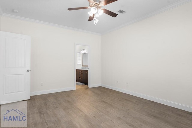 empty room featuring light hardwood / wood-style floors, ceiling fan, and crown molding