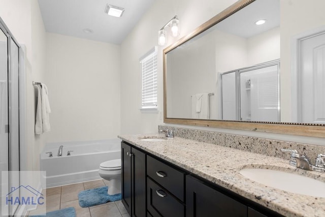 full bathroom with tile patterned flooring, shower with separate bathtub, vanity, and toilet