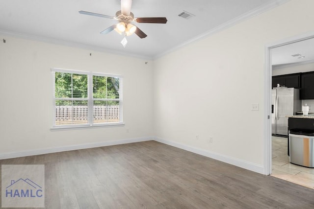 unfurnished room featuring ceiling fan, crown molding, and light hardwood / wood-style flooring