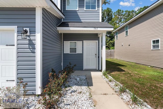 doorway to property featuring a lawn