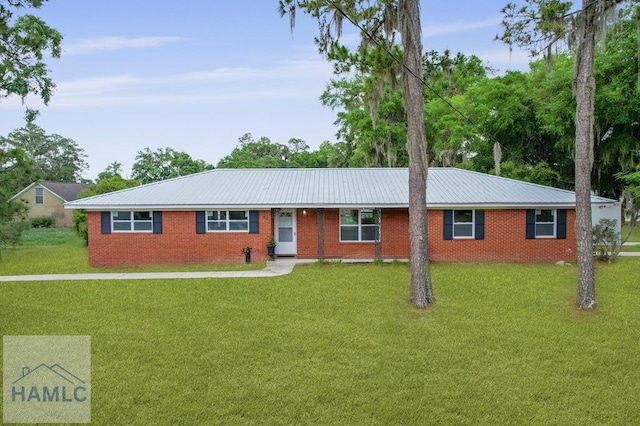 ranch-style house featuring a front yard, brick siding, and metal roof