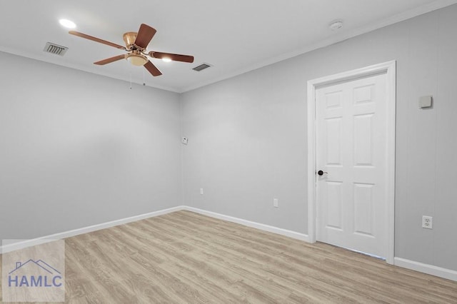 unfurnished room featuring light wood-type flooring, a ceiling fan, baseboards, ornamental molding, and a smoke detector