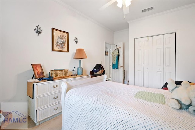 carpeted bedroom featuring ceiling fan, ornamental molding, and a closet