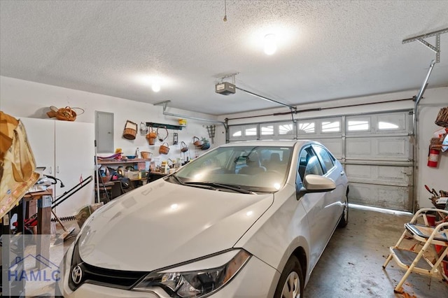 garage with electric panel and a garage door opener