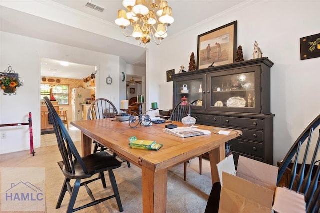 dining area with a notable chandelier and crown molding