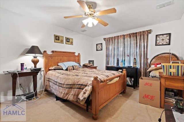 bedroom with ceiling fan and light colored carpet