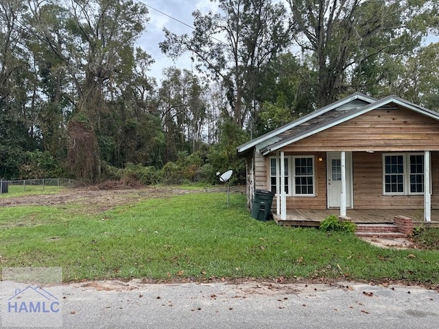 view of front of house with a front yard and a porch