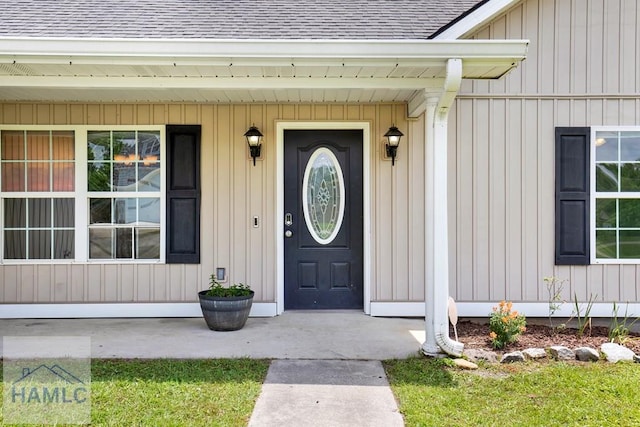 29 Joy Ln, Midway, GA 31320 - doorway to property with a shingled roof, covered porch, and board and batten siding