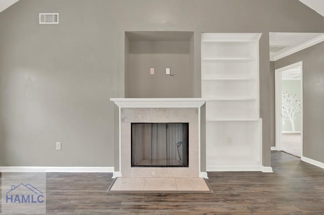 29 Joy Ln, Midway, GA 31320 - unfurnished living room with wood finished floors, baseboards, built in features, ornamental molding, and a tiled fireplace