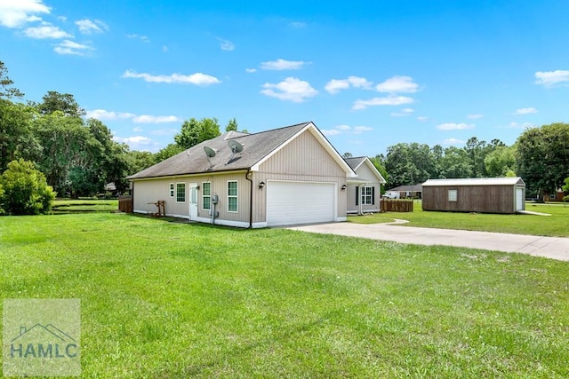 29 Joy Ln, Midway, GA 31320 - ranch-style home with concrete driveway, a front yard, an attached garage, and view of wooded area