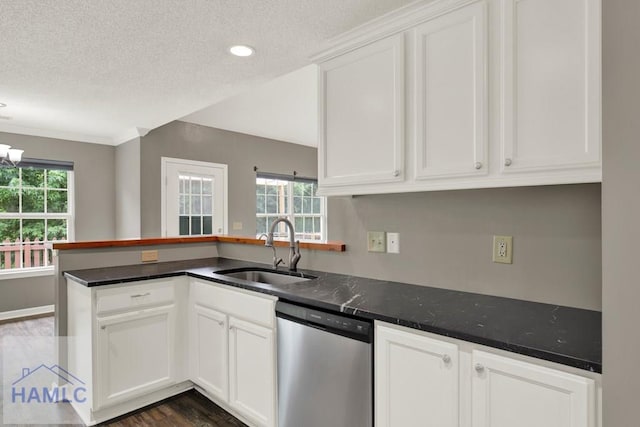 29 Joy Ln, Midway, GA 31320 - kitchen with dishwasher, a sink, a textured ceiling, a peninsula, and white cabinetry