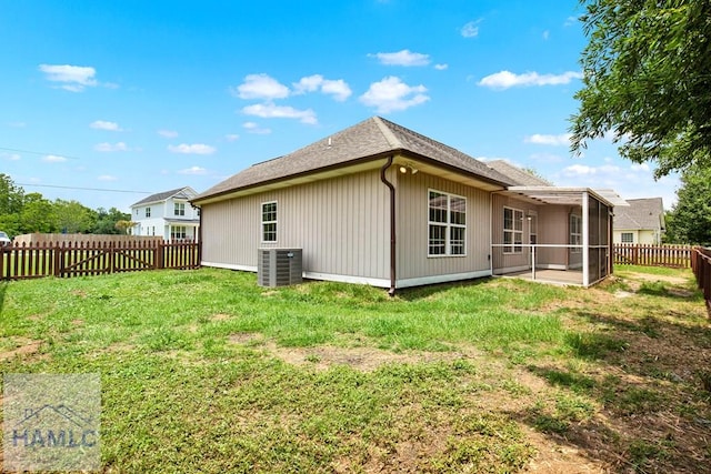 29 Joy Ln, Midway, GA 31320 - rear view of property featuring a sunroom, central AC unit, and a shingled roof