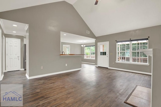29 Joy Ln, Midway, GA 31320 - unfurnished living room with baseboards, high vaulted ceiling, dark wood-style flooring, ceiling fan, and a chandelier