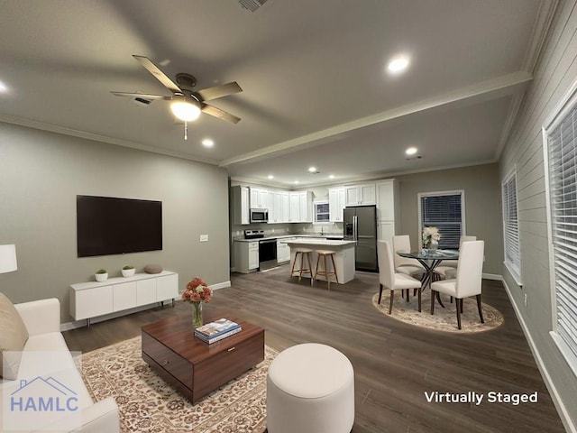 living room with ceiling fan, ornamental molding, and dark wood-type flooring