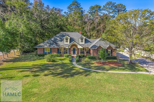 cape cod home featuring a front lawn