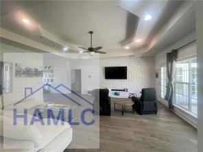 485 Cody Dr, Jesup, GA 31545 - living area with a tray ceiling, wood finished floors, ceiling fan, and recessed lighting