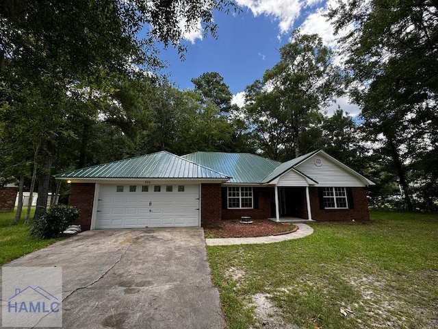 single story home featuring concrete driveway, a front lawn, an attached garage, brick siding, and metal roof
