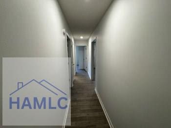 corridor with recessed lighting, baseboards, and dark wood-style flooring