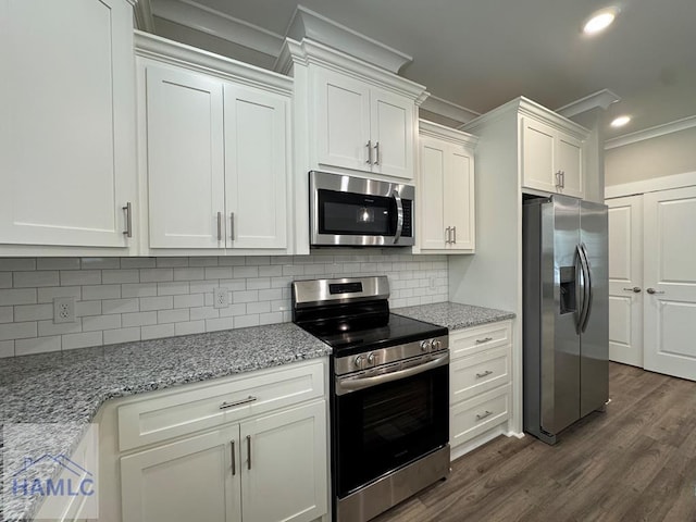 193W Melody Dr, Jesup, GA 31545 - kitchen with appliances with stainless steel finishes, ornamental molding, white cabinets, backsplash, and dark wood-style floors