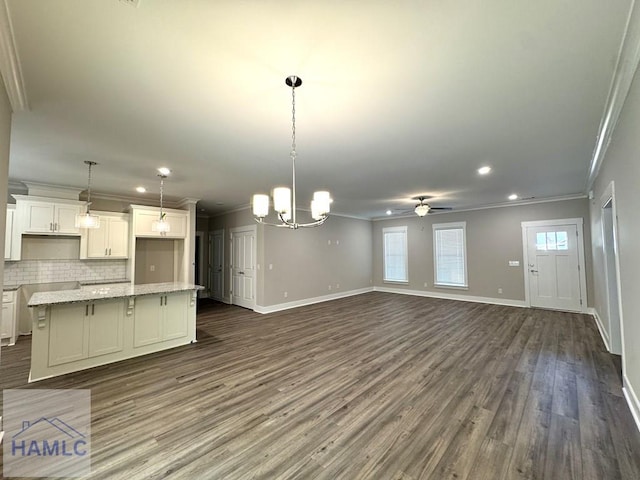 193W Melody Dr, Jesup, GA 31545 - unfurnished living room featuring crown molding, dark wood-type flooring, a ceiling fan, recessed lighting, and a chandelier