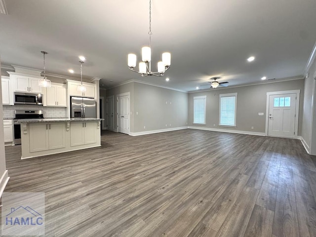 193W Melody Dr, Jesup, GA 31545 - unfurnished living room featuring ceiling fan, ornamental molding, dark wood-style floors, a chandelier, and recessed lighting