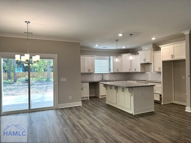 193W Melody Dr, Jesup, GA 31545 - kitchen with plenty of natural light, a kitchen island, decorative backsplash, ornamental molding, and recessed lighting