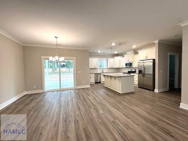 193W Melody Dr, Jesup, GA 31545 - kitchen with appliances with stainless steel finishes, dark wood-style floors, a center island, open floor plan, and white cabinetry