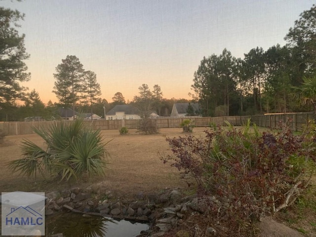 view of yard at dusk