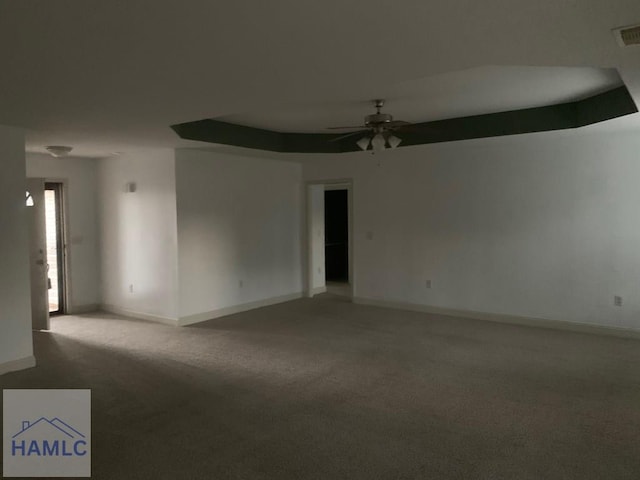 spare room featuring ceiling fan and carpet floors