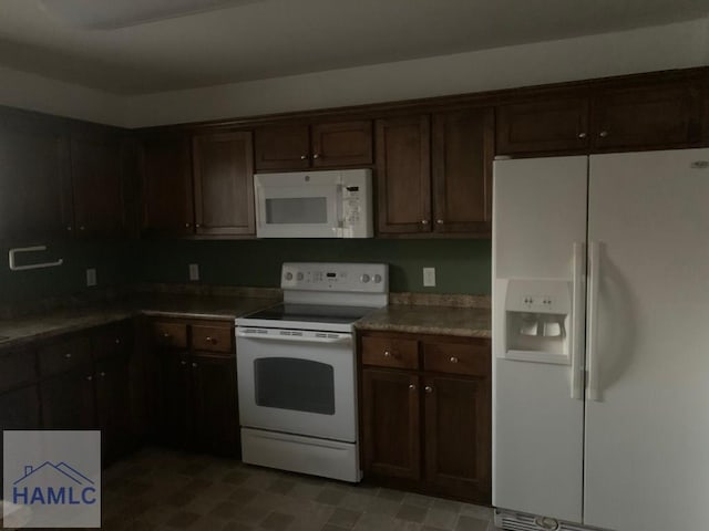 kitchen featuring dark brown cabinetry and white appliances