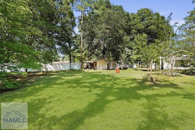 265 Mahan St, Jesup, GA 31545 - fenced backyard with a storage unit