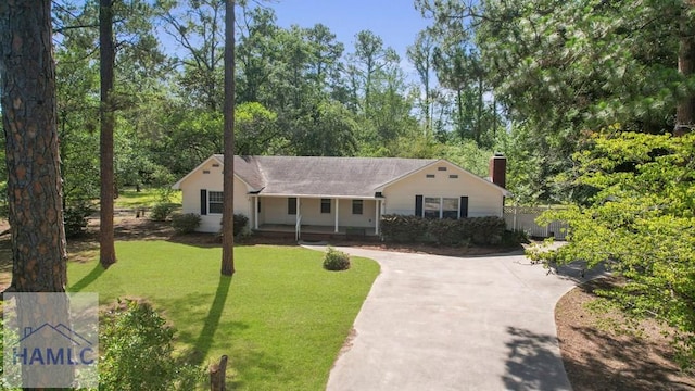 265 Mahan St, Jesup, GA 31545 - view of front of home featuring a porch, a chimney, roof with shingles, and driveway
