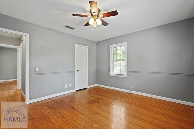 265 Mahan St, Jesup, GA 31545 - unfurnished bedroom with wood finished floors and ceiling fan