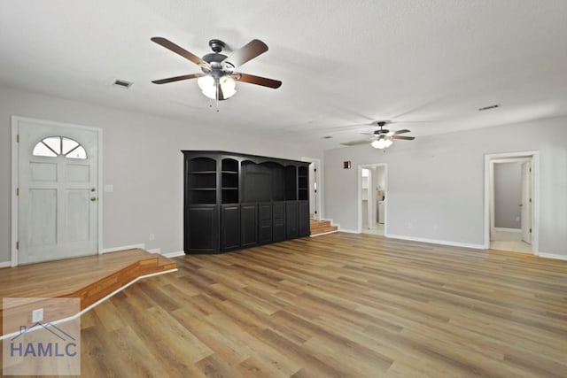 265 Mahan St, Jesup, GA 31545 - unfurnished living room with ceiling fan, light wood finished floors, and a textured ceiling