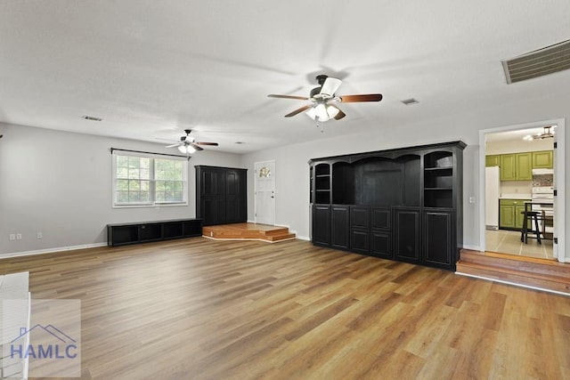 265 Mahan St, Jesup, GA 31545 - unfurnished living room featuring ceiling fan and light wood finished floors