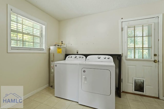 265 Mahan St, Jesup, GA 31545 - laundry area with electric water heater, independent washer and dryer, plenty of natural light, and light tile patterned flooring
