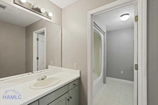 265 Mahan St, Jesup, GA 31545 - bathroom with vanity, tile patterned flooring, and a textured ceiling
