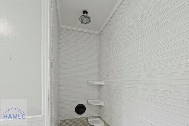265 Mahan St, Jesup, GA 31545 - bathroom featuring crown molding and a tile shower