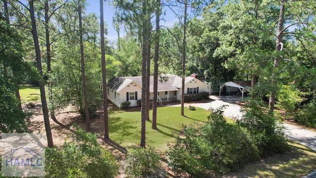 265 Mahan St, Jesup, GA 31545 - view of front of house with a carport, driveway, and a front yard