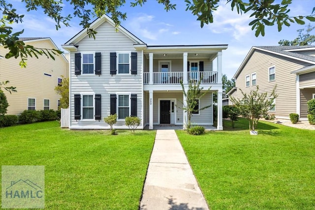 view of front facade featuring a balcony and a front yard