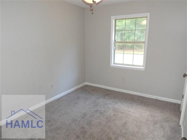 1111 Apache Aly, Hinesville, GA 31313 - carpeted empty room featuring baseboards