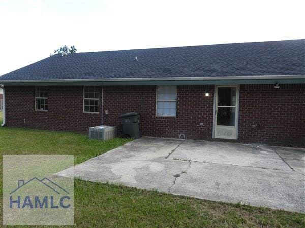1111 Apache Aly, Hinesville, GA 31313 - back of house featuring a patio, brick siding, a lawn, and a shingled roof