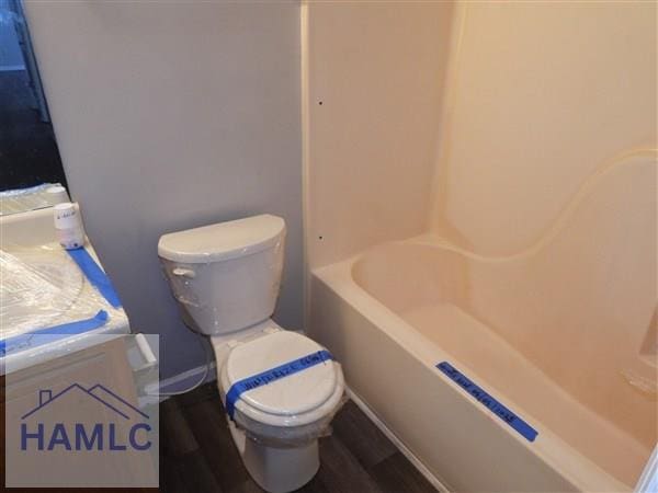 1111 Apache Aly, Hinesville, GA 31313 - bathroom featuring vanity, wood finished floors, and shower / tub combination