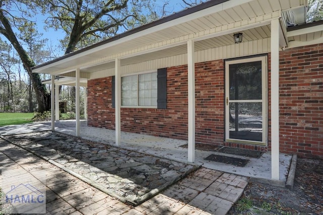 property entrance with brick siding