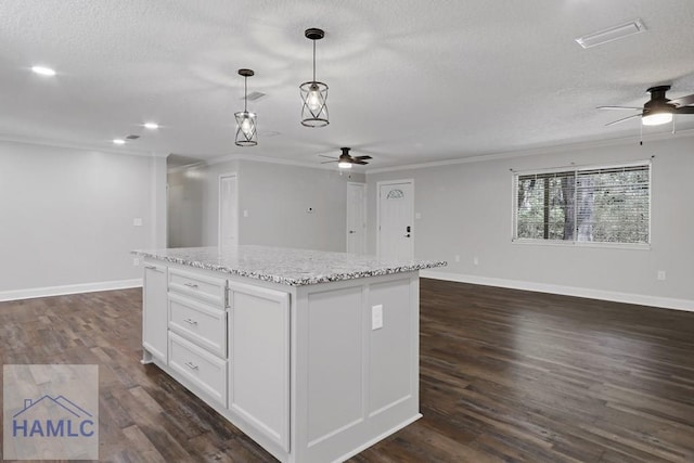 kitchen with open floor plan, a textured ceiling, and a center island