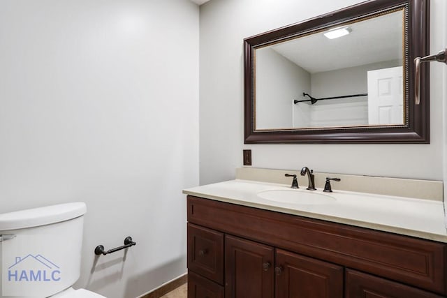 bathroom with toilet and vanity