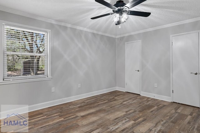 spare room with crown molding, ceiling fan, baseboards, wood finished floors, and a textured ceiling