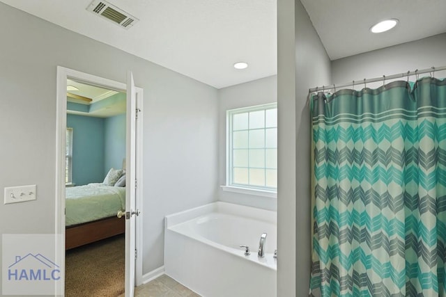 138 Forest St NE, Ludowici, GA 31316 - full bath featuring a bath, connected bathroom, and a shower with curtain