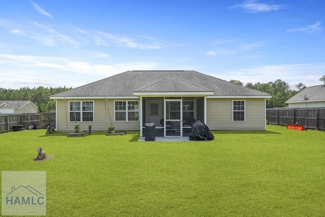 138 Forest St NE, Ludowici, GA 31316 - rear view of property featuring a shingled roof, a fenced backyard, and a sunroom