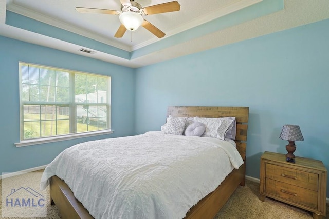 138 Forest St NE, Ludowici, GA 31316 - carpeted bedroom with crown molding, a tray ceiling, and a ceiling fan